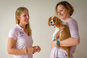 Puppy School tutor talking to owner holding a Cavalier King Charles Spaniel puppy